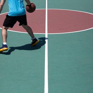 man dribbling ball on court