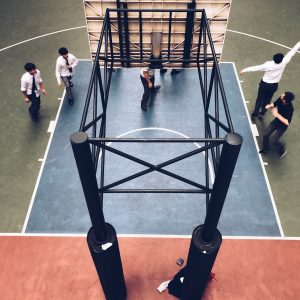 people standing under basketball hoop
