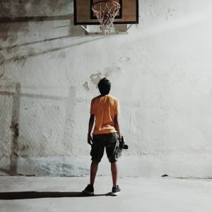 man looking basketball ring
